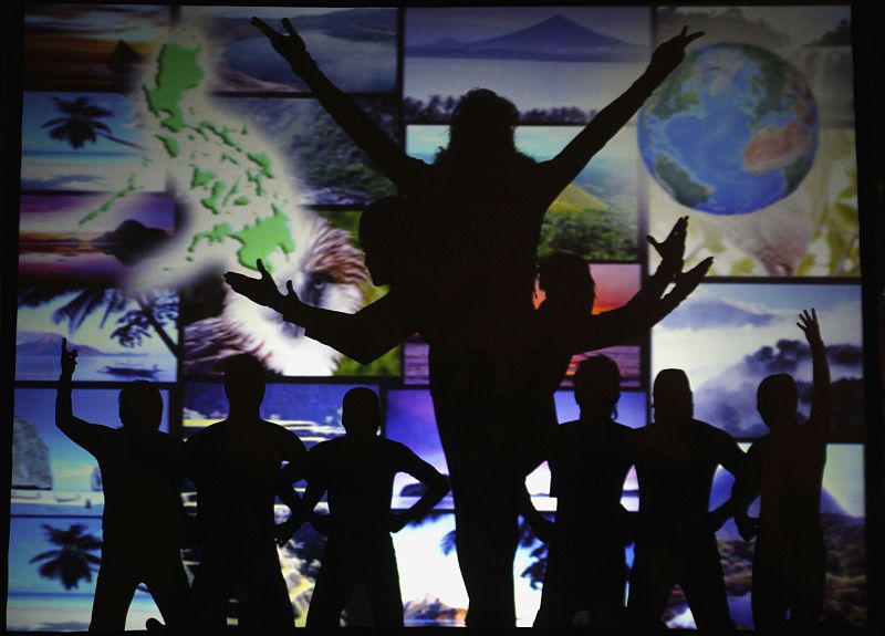Performers use their shadows as they form different environmental themes during celebration of Earth Hour in Manila's Makati financial district