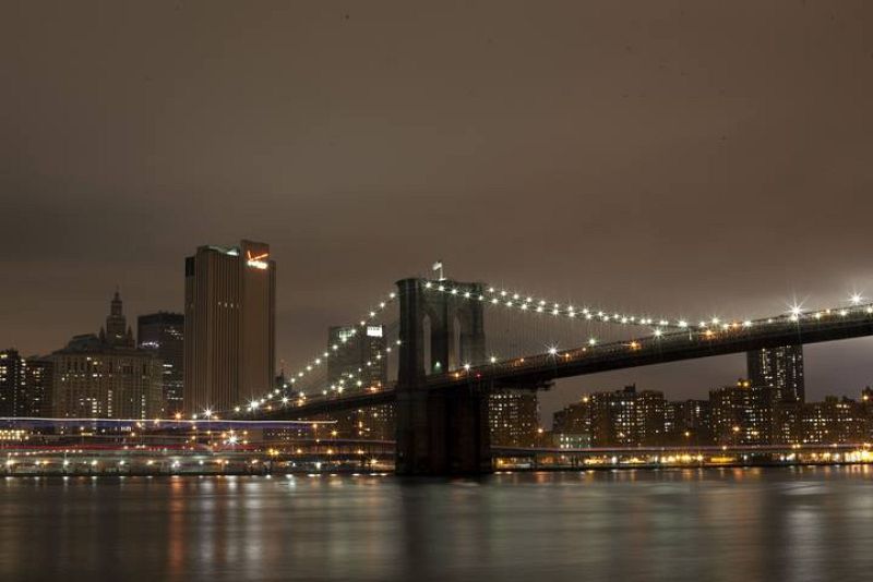 The Brooklyn Bridge is seen before the lights are turned off, in participation with Earth Hour, in New York