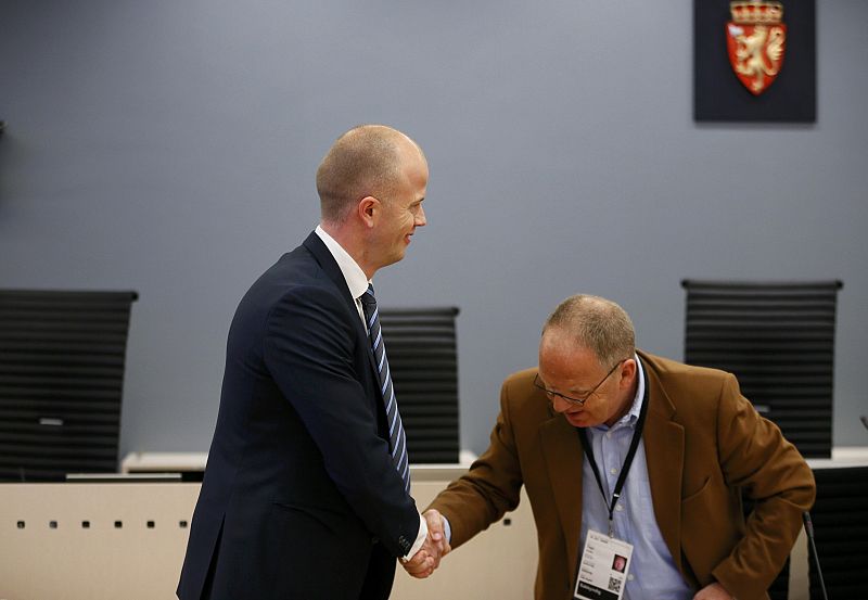Public prosecutor Holden shakes hands with psychiatrist Husby during the first day of the trial against Anders Behring Breivik in Oslo