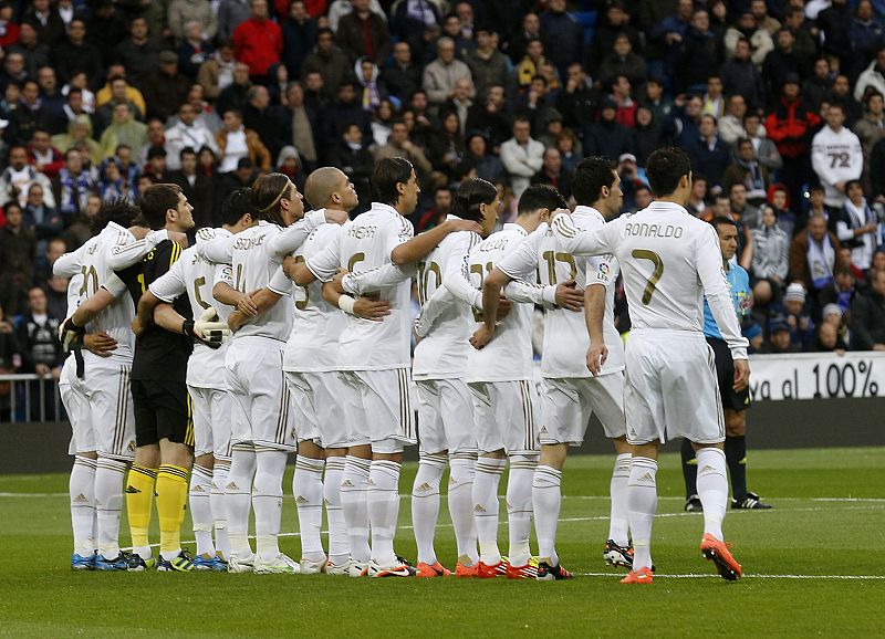 Real Madrid players hold a minute of silence for Livorno's Piermario Morosini before their Spanish First Division soccer match and Sporting Gijon in Madrid