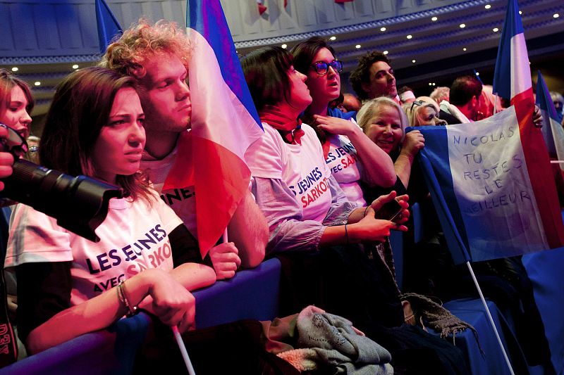Supporters of Nicolas Sarkozy, France's President and UMP party candidate for his re-election, wait for results in the second round vote of the 2012 French presidential elections at the Mutualite meeting hall in Paris
