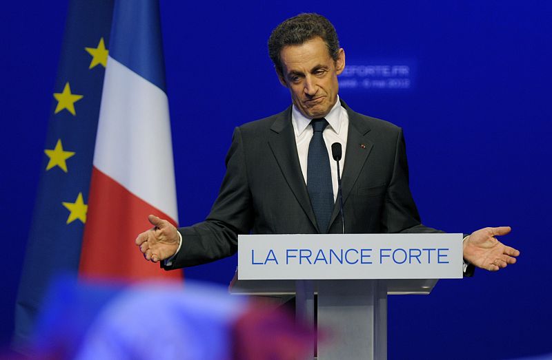 Nicolas Sarkozy, France's incumbent president, reacts after his defeat for re-election in the second round vote of the 2012 French presidential elections as he appears on stage before UMP party supporters at the Mutualite meeting hall in Paris