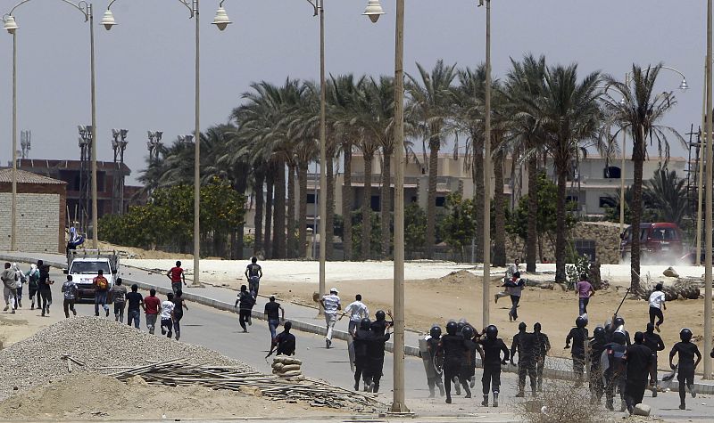 Riot police clash with anti-Mubarak protesters after a court sentenced deposed president Hosni Mubarak to life in prison, outside the police academy where the court is located in Cairo