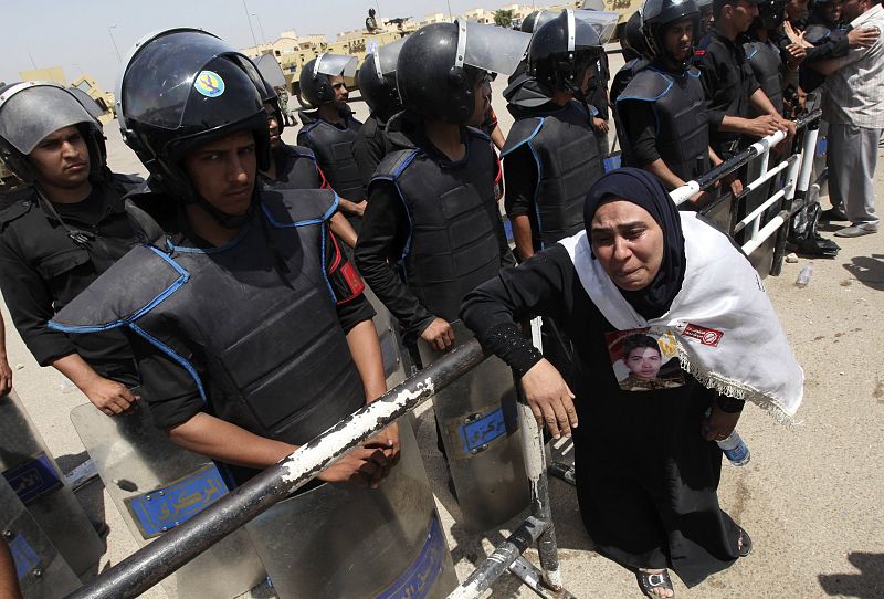 Relatives of people who's died during Egypt's revolution react after a court sentenced deposed president Hosni Mubarak to life in prison, outside the police academy where the court is located in Cairo
