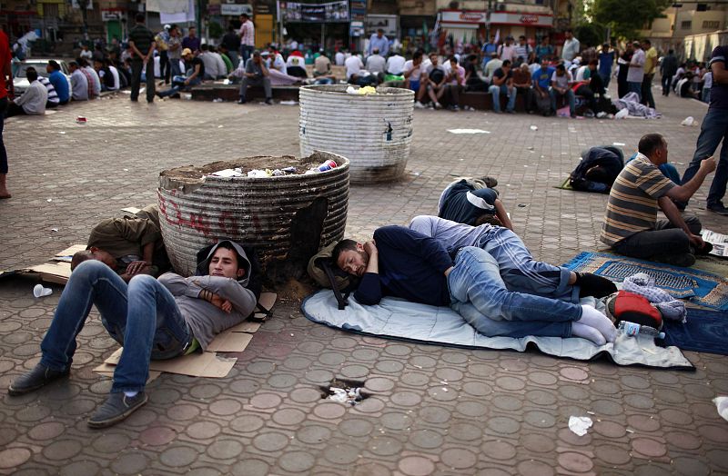 People sleep during a sit-in at Tahrir Square, after a court sentenced deposed president Mubarak to life in prison, in Cairo