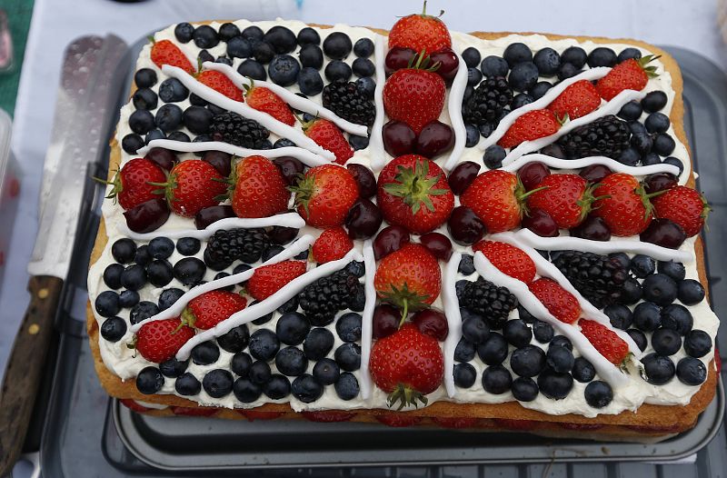 A cake in the shape of a Union Jack sits on a table during a street party to celebrate Queen Elizabeth's Diamond Jubilee in Marple Bridge