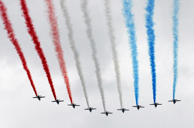 Alphajet planes from the Patrouille de France fly over the Champs Elysees as part of the traditional Bastille Day military parade in Paris