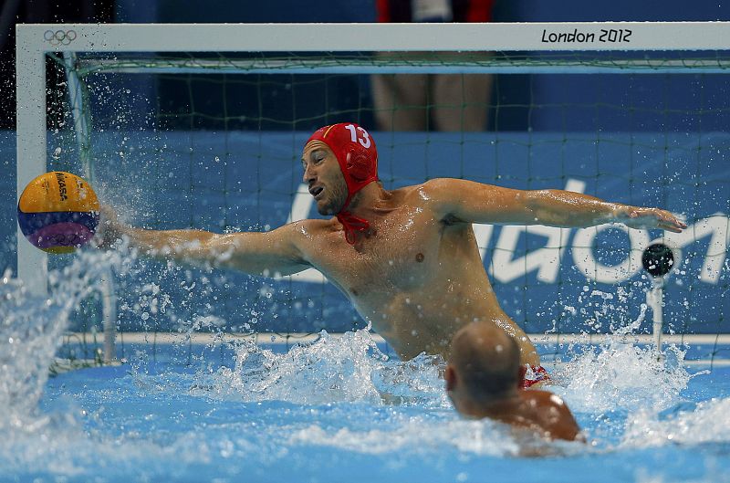 Spain's Daniel Lopez Pinedo dives for the ball during their men's preliminary round Group A water polo match against Kazakhstan at the Water Polo Arena during the London 2012 Olympic Games
