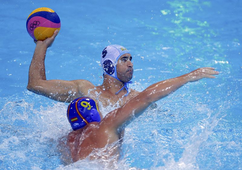 Spain's  Xavier Valles Trias challenges Kazakhstan's Alexey Panfili during their men's preliminary round Group A water polo match at the Water Polo Arena during the London 2012 Olympic Games