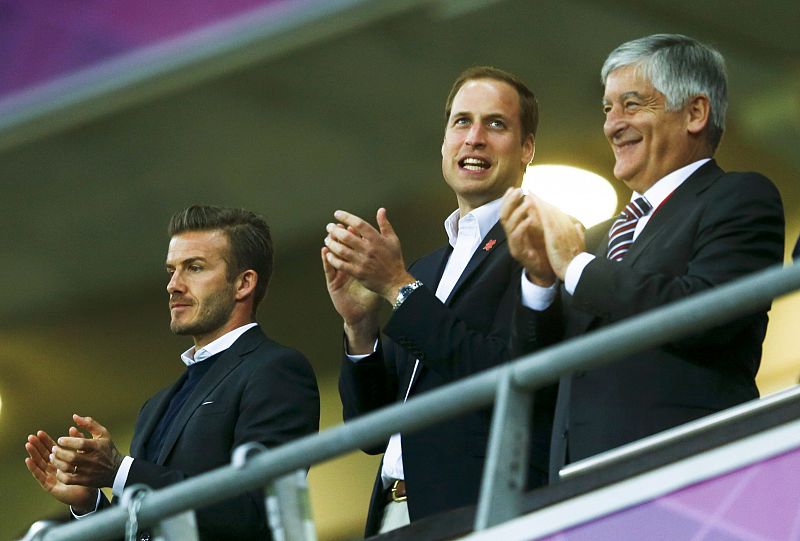 Britain's Prince William, soccer ace David Beckham (L) and with Britain's Sports Minister Hugh Robertson watch the men's preliminary first round Group A soccer match between Britain and UAE at the London 2012 Olympic Games in the Wembley Stadium in L