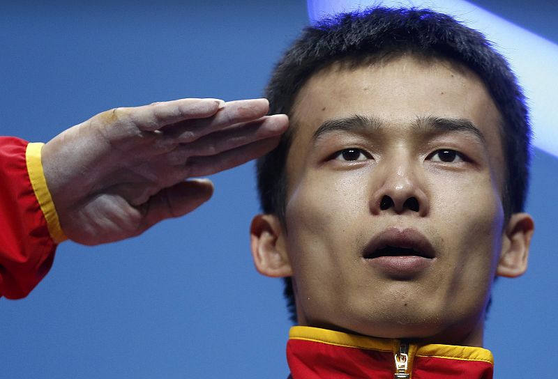 China's Jingbiao Wu salutes at the podium after getting silver medal on the men's 56Kg Group A weightlifting competition at the London 2012 Olympic Games