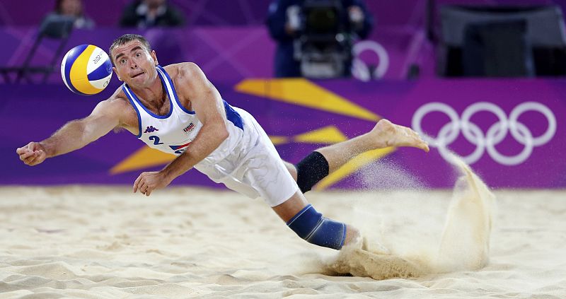 Czech Republic's Petr Benes dives for the ball during their men's preliminary round beach volleyball match against Todd Rogers and Phil Dalhausser of the U.S. at Horse Guards Parade during the London 2012 Olympic Games