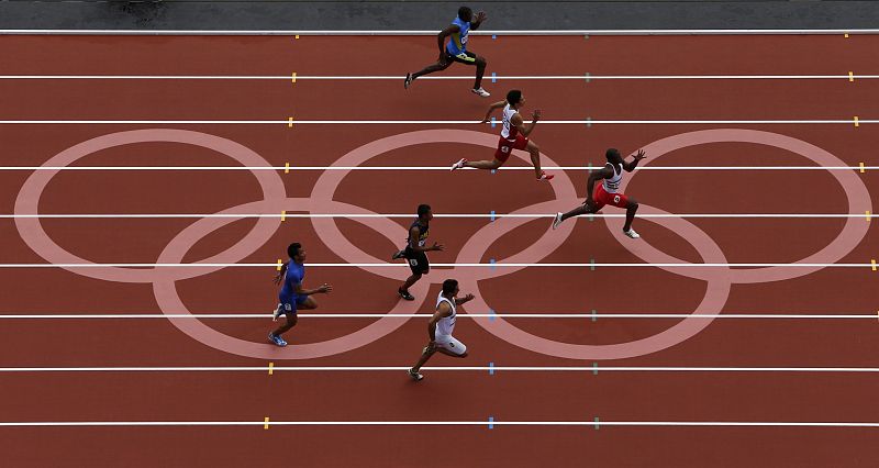 Athletes compete in round 1 of the men's 100m heats at the London 2012 Olympic Games at the Olympic Stadium