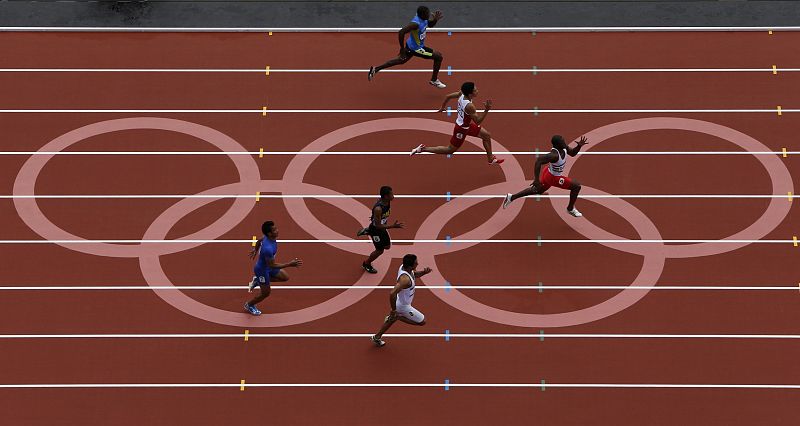 Athletes compete in round 1 of the men's 100m heats at the London 2012 Olympic Games at the Olympic Stadium