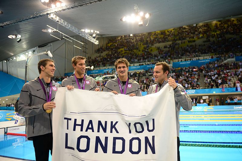 Matthews Grevers, Brendan Hansen, Michael Phelps y Adrian Nathan, oro en 4x100 metros estilos representando a EE.UU., sostienen una pancarta en la que reza: Gracias, Londres.