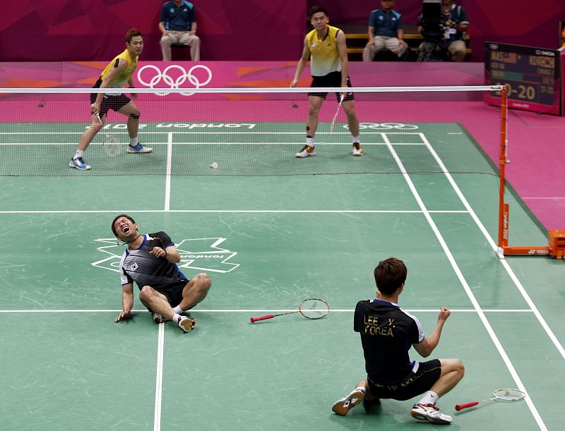 South Korea's Lee Yong-dae and Chung Jae-sung celebrate after winning their men's doubles badminton bronze medal match against Malaysia at the London 2012 Olympic Games at the Wembley Arena