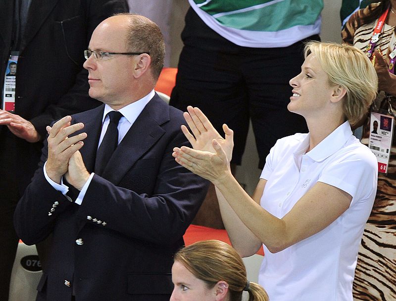 El Príncipe Alberto II de Mónaco y la Princesa Charlene Wittstock observan una competencia de natación en el Centro Acuático.