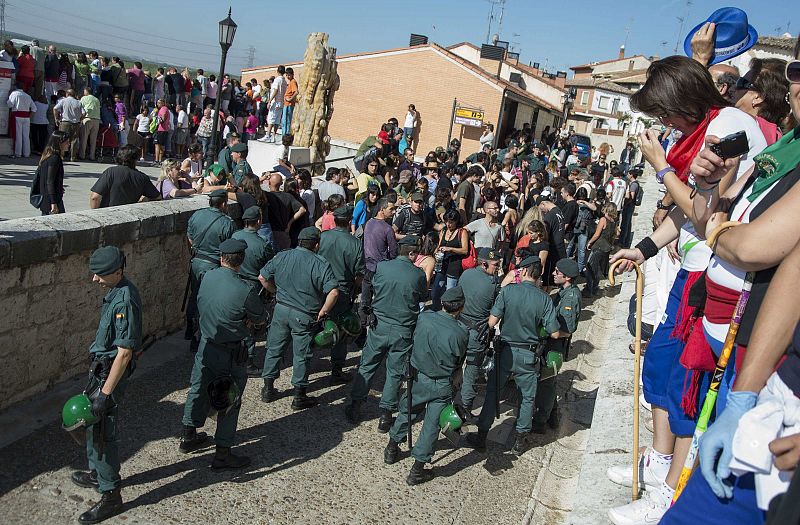 Animal rights activists are surrounded by Spanish Civil Guard during the "Toro de la Vega" festival in Tordesillas, near Valladolid