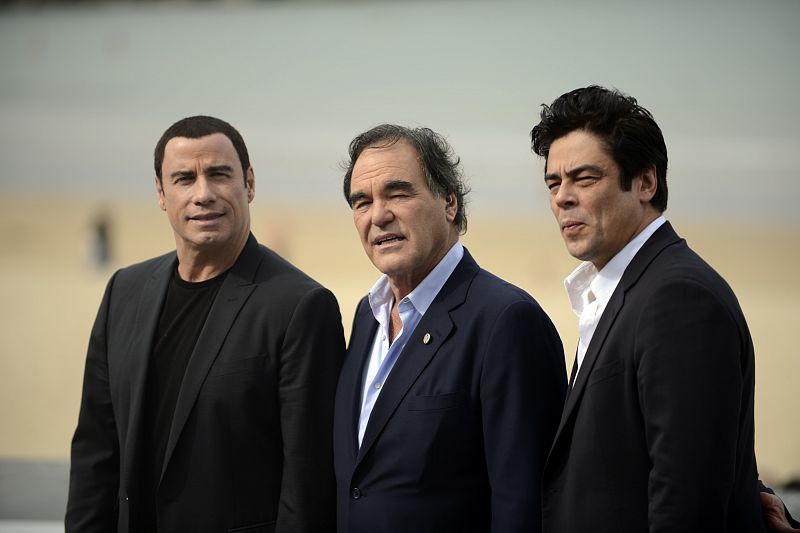 Travolta, Stone and del Toro pose during a photocall to promote the film Savages on the third day of the San Sebastian Film Festiva