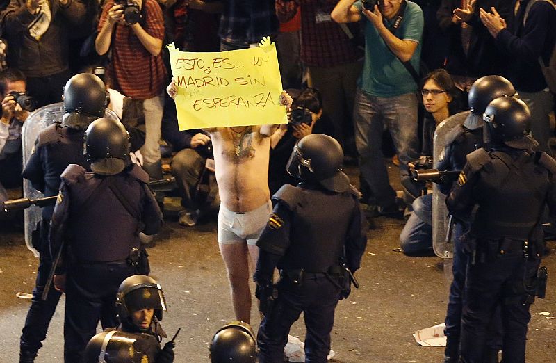 Protester holds a poster during a demonstration outside the Spanish parliament in Madrid