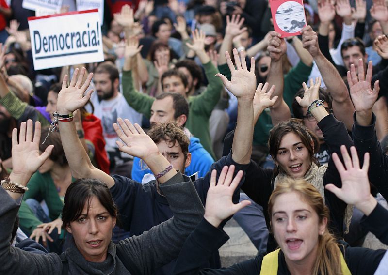 Protesters shout slogans during a demonstration outside Madrid's Parliament