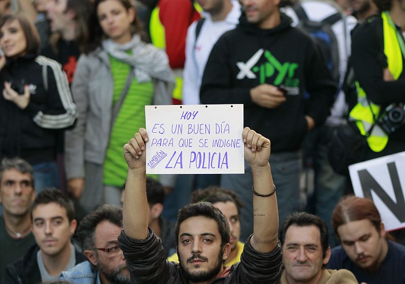 Protester holds up a placard during a demonstration outside Madrid's Parliament