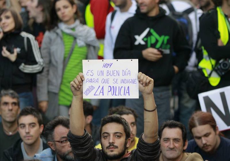 Protester holds up a placard during a demonstration outside Madrid's Parliament