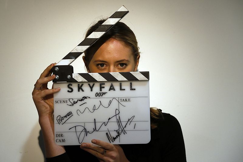 A worker holds a clapperboard from the film "Skyfall" during a media preview of "50 Years of James Bond - the Auction", at Christie's in London