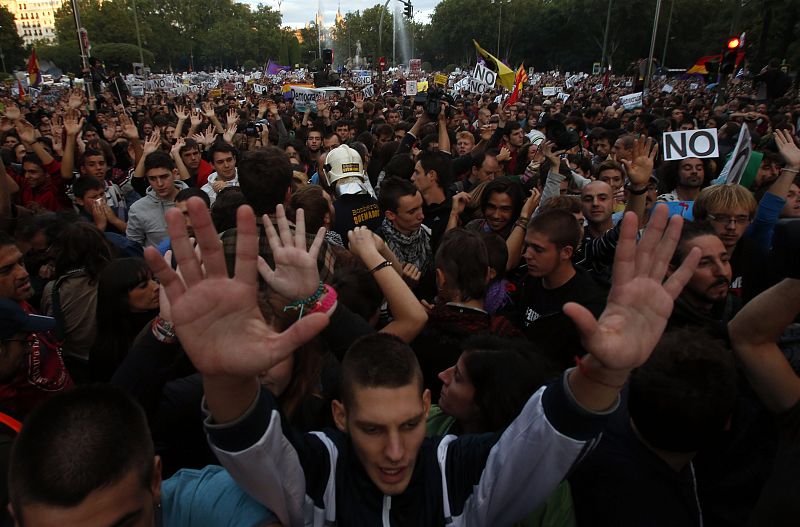 Protesters shout slogans as they fill up Neptuno Square during a demonstration against government austerity measures in Madrid