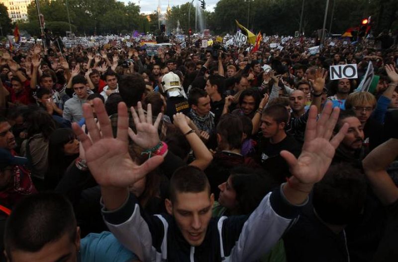 Protesters shout slogans as they fill up Neptuno Square during a demonstration against government austerity measures in Madrid