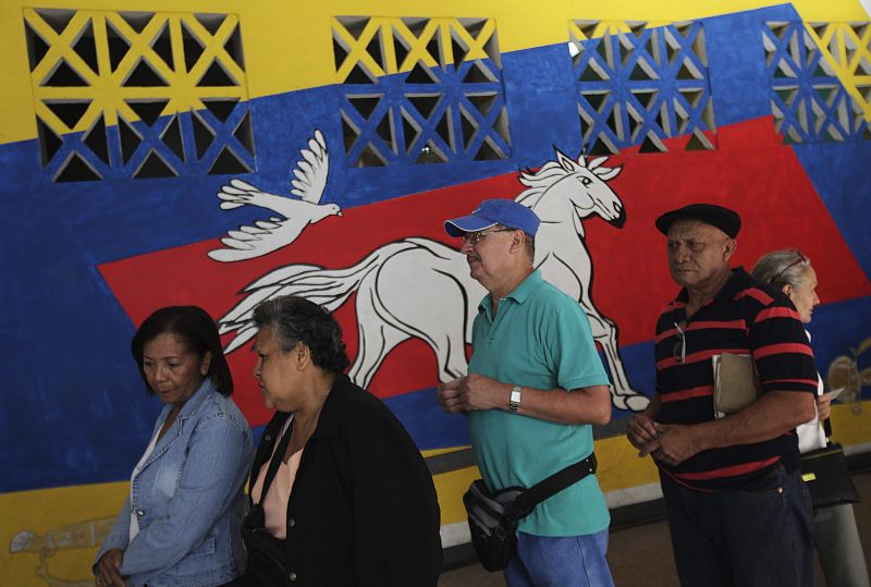 Venezuelans line up outside a voting station during the presidential election in Caracas