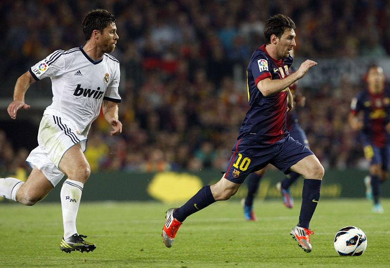 Barcelona's Messi is followed by Real Madrid's Alonso during their Spanish first division soccer match at Nou Camp stadium in Barcelon