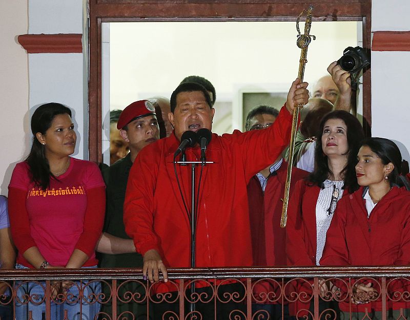 President Hugo Chavez holds the sword used by former Venezuelan military leader Simon Bolivar while celebrating from a balcony at Miraflores Palace