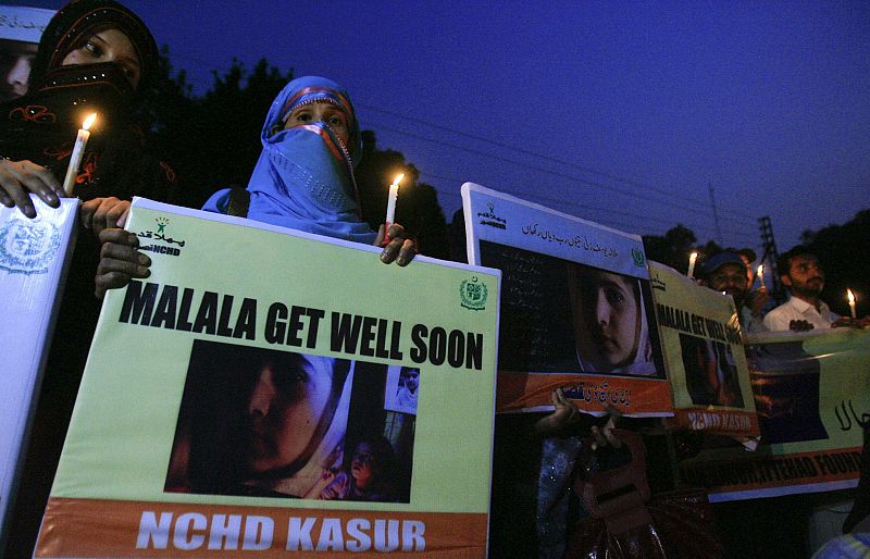 NCHD supporters hold pictures of schoolgirl Yousufzai, who was shot by the Taliban, during a rally in Lahore