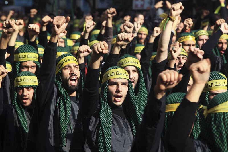 Lebanon's Hezbollah supporters gesture as they march during a ceremony to mark Ashura in Beirut's suburbs