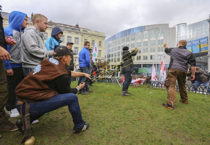 Varios productores de leche europeos lanzan globos de agua mientras protestan cerca de la sede del Parlamento Europeo en Bruselas