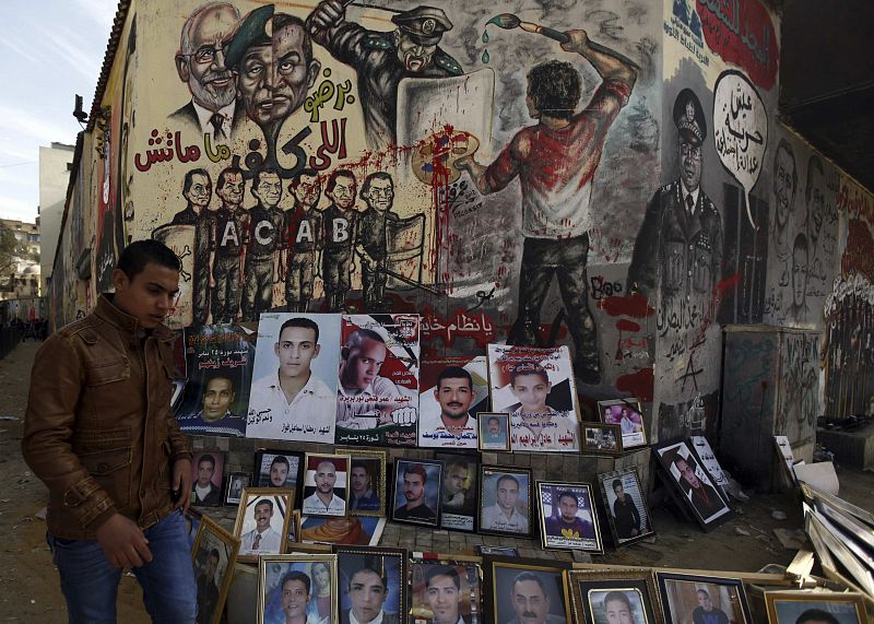 Fotografías de "mártires" caídos en la lucha por la democracia en Egipto. Al fondo, un grafiti funde las imágenes de Mubarak con las de Mohamed Hussein Tantaui, exjefe del gobierno militar, y el líder los Hermanos Musulmanes Mohammed Badie.