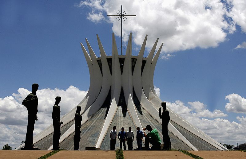 File photo of tourists taking pictures in front of the Metropolitan Cathedral designed by architect Oscar Niemeyer in Brasilia