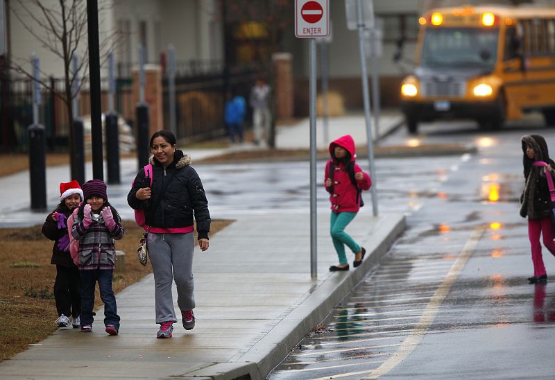 Una mujer y una niños recorren las afueras de la escuela de primaria Ellsworth después de que la clase fuera suspendida en Danbury, Connecticut.