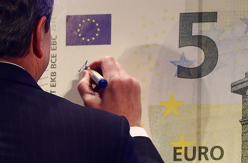 Draghi, President of the European Central Bank (ECB), signs an oversized new unveiled 5 euro note in Frankfurt