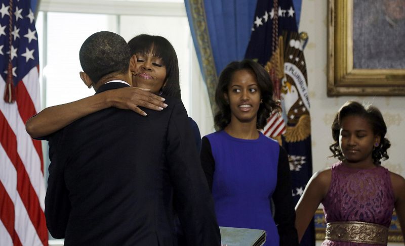 U.S. President Barack Obama hugs his wife Michelle after taking the official oath of office from Supreme Court Chief Justice John Roberts at the White House in Washington