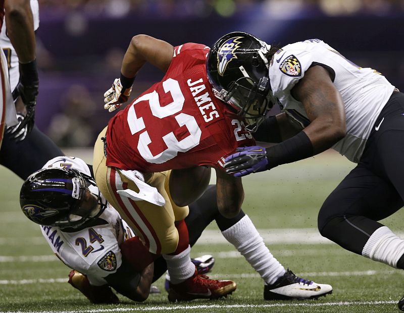 Baltimore Ravens' Upshaw causes San Francisco 49ers' James to fumble as he is tackled by cornerback Graham during the second quarter in the NFL Super Bowl XLVII football game in New Orleans