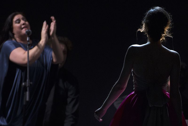 A singer performs as a model presents a creation from Duyos' Fall/Winter 2013 collection during the Mercedes-Benz Fashion Week in Madrid