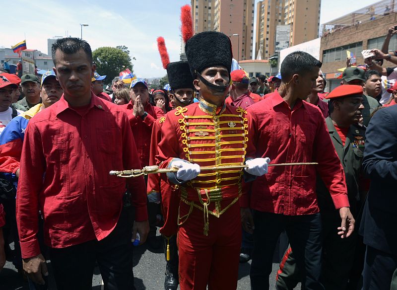 Una miembro de la Guardia de Honor Presidencial de Venezuela sostiene una réplica de la espada de Simon Bolivar en el acompañamiento del coche fúnebre de Hugo Chávez