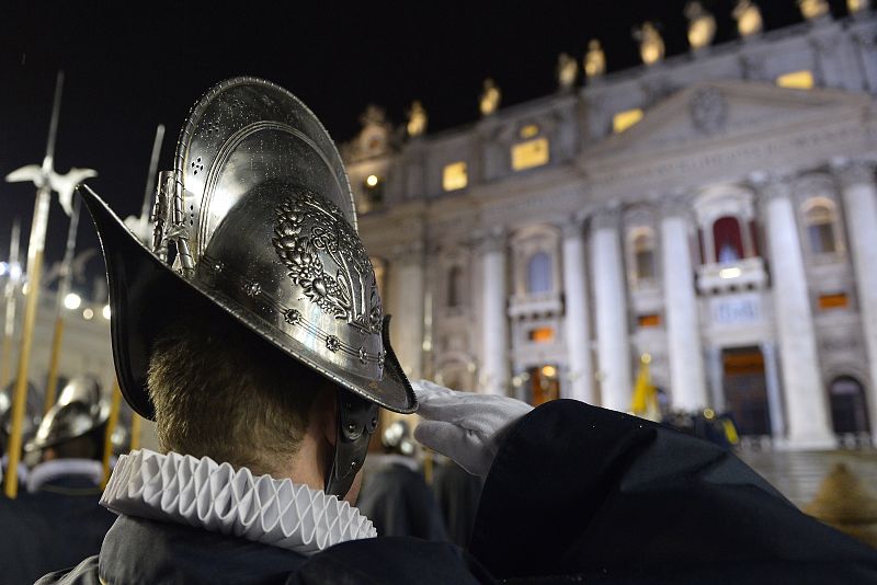 Uno de los miembros de la guardia suiza saluda hacia el balcón donde se anuncia el nombre de nuevo papa