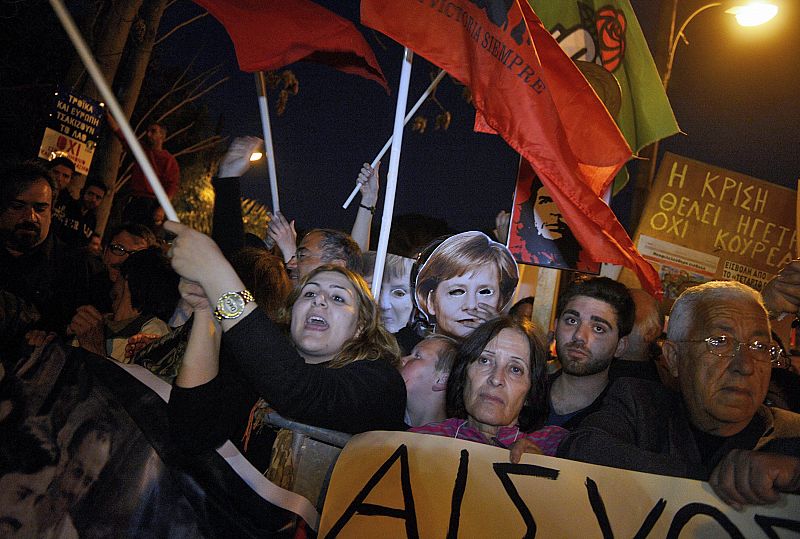 Los manifestantes chipriotas muestran su rechazo a la troika propuesta por la canciller alemana Angela Merkel