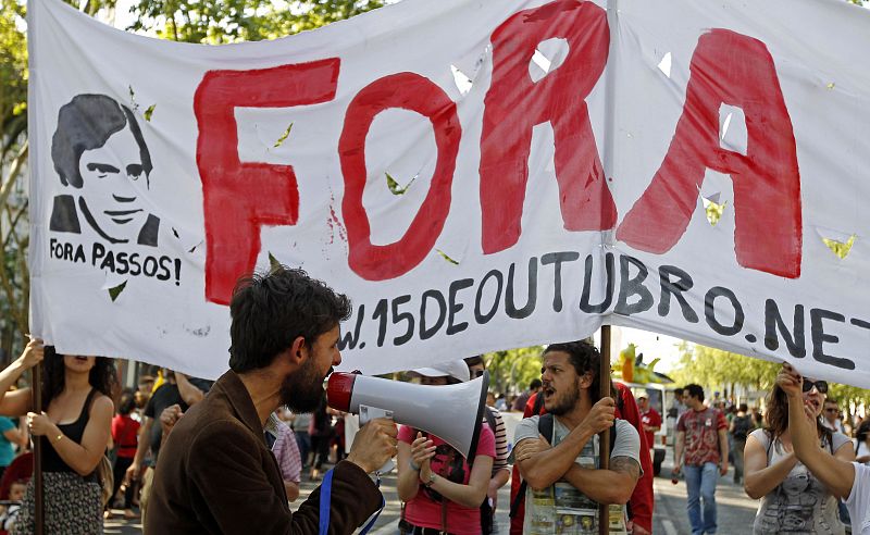 A man shouts slogans using a megaphone during a march celebrating the 39th anniversary of the Carnation Revolution in Lisbon