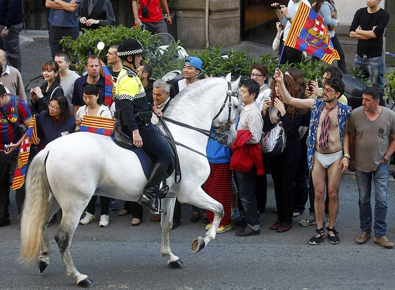 Aficionados del Barcelona esperan la llegada de su equipo para celebrar el título de Ligaon the streets of Barcelona