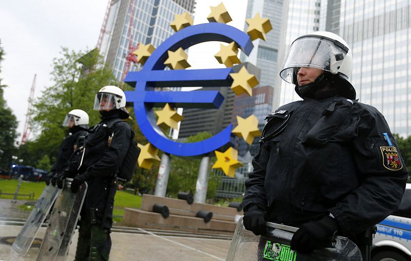 Riot police stand near the euro sign in front of the European Central Bank headquarters during an anti-capitalist "Blockupy" demonstration in Frankfurt