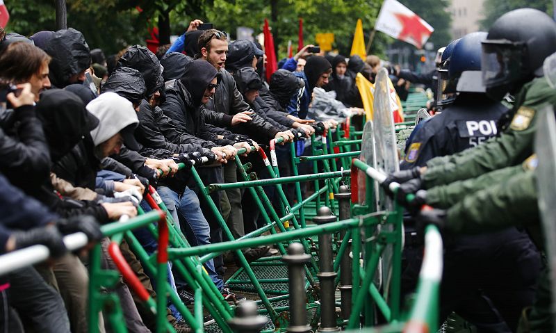 Riot police try to prevent protestors from breaking through barricades near the ECB headquarters during a "Blockupy" demonstration in Frankfurt